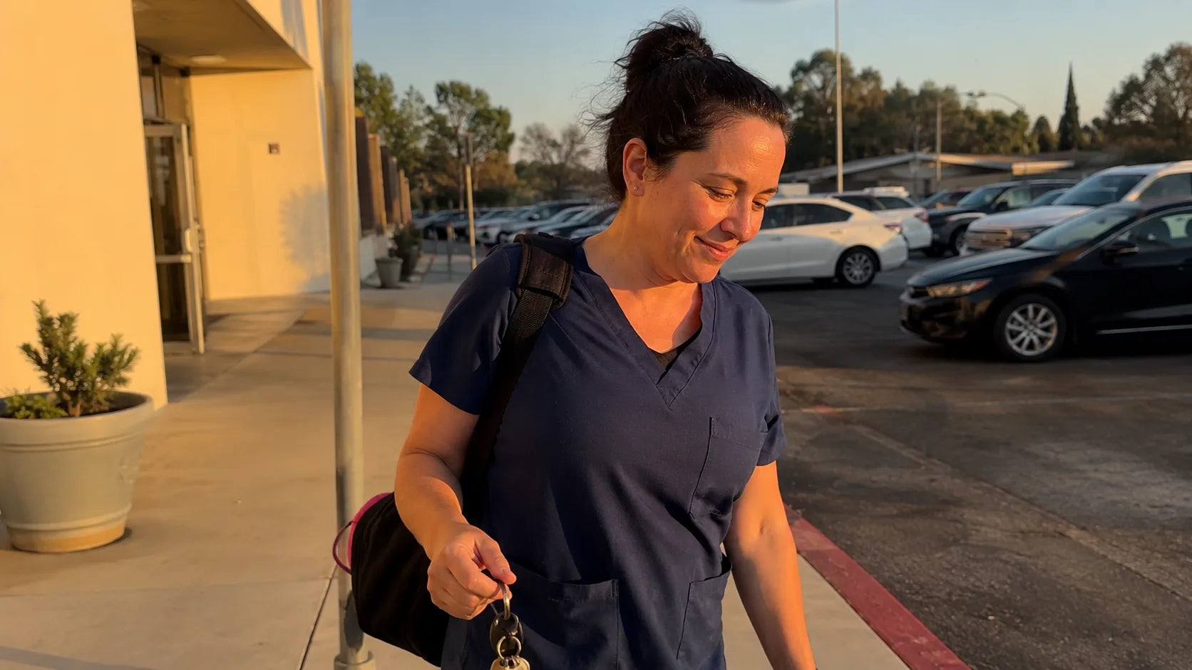 Worker walking out after a shift, relaxed