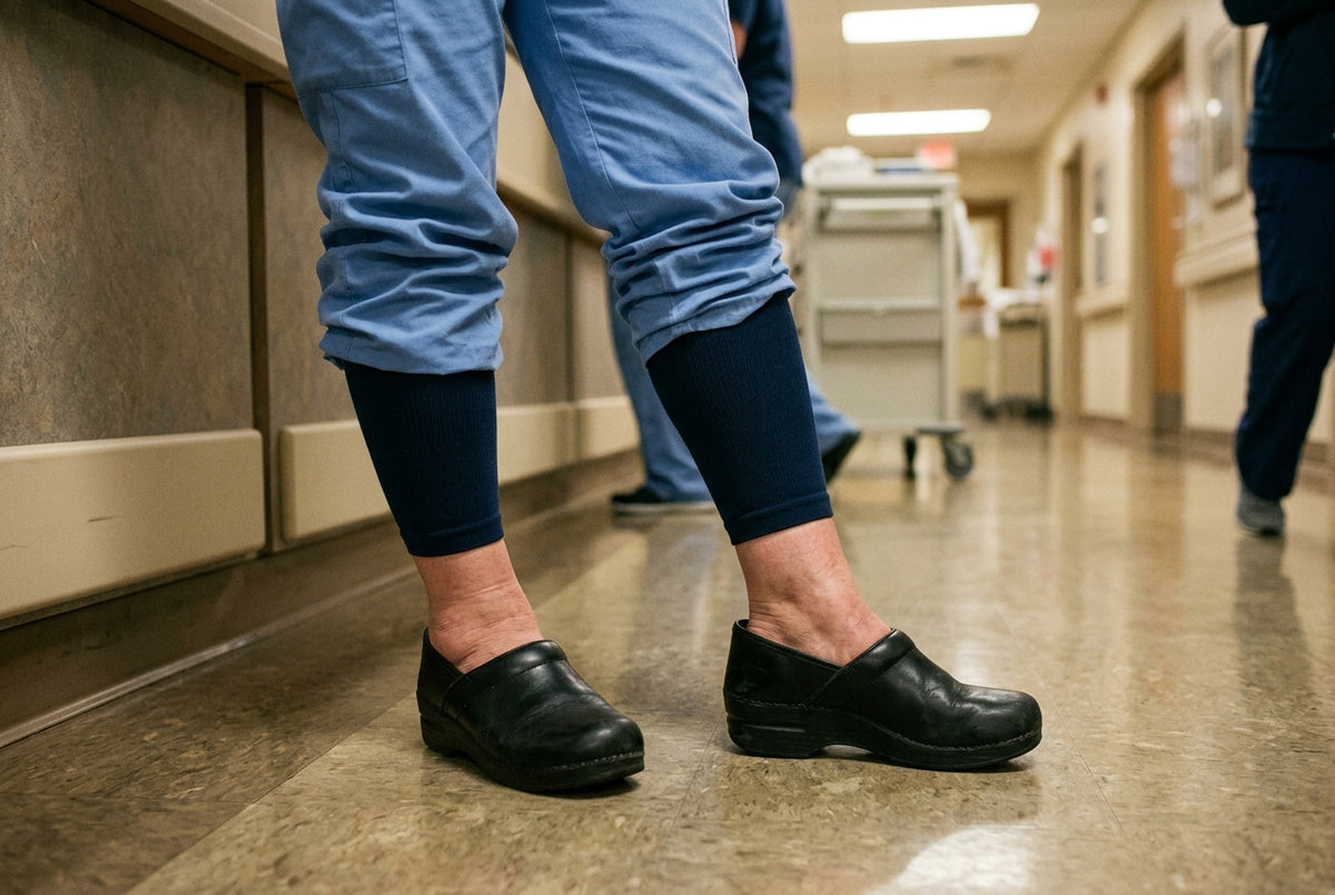 A nurse standing still on a hospital floor during a long shift