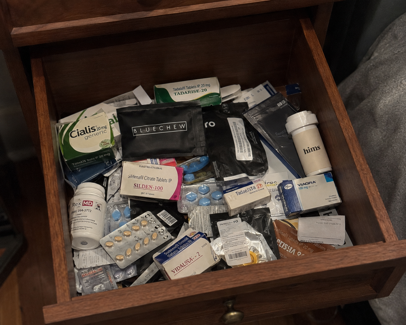 A nightstand drawer full of ED pills, tablets and delay sprays
